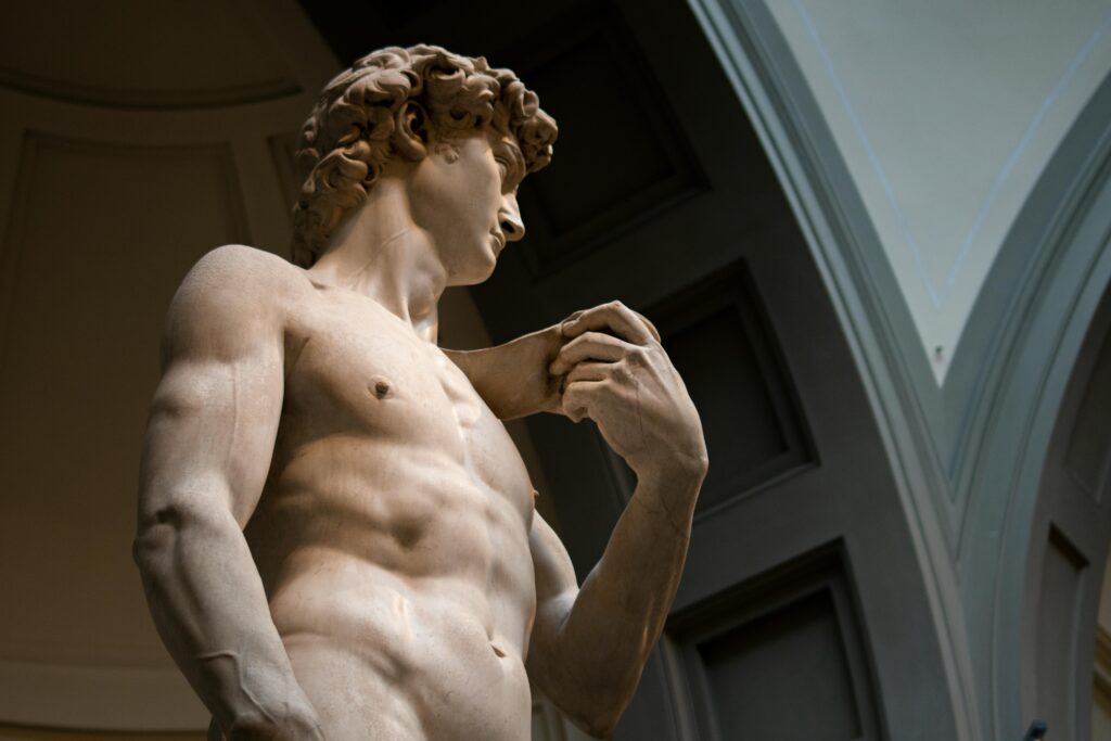 Low angle view of Michelangelo's Statue of David, showcasing its intricate details in Florence museum.