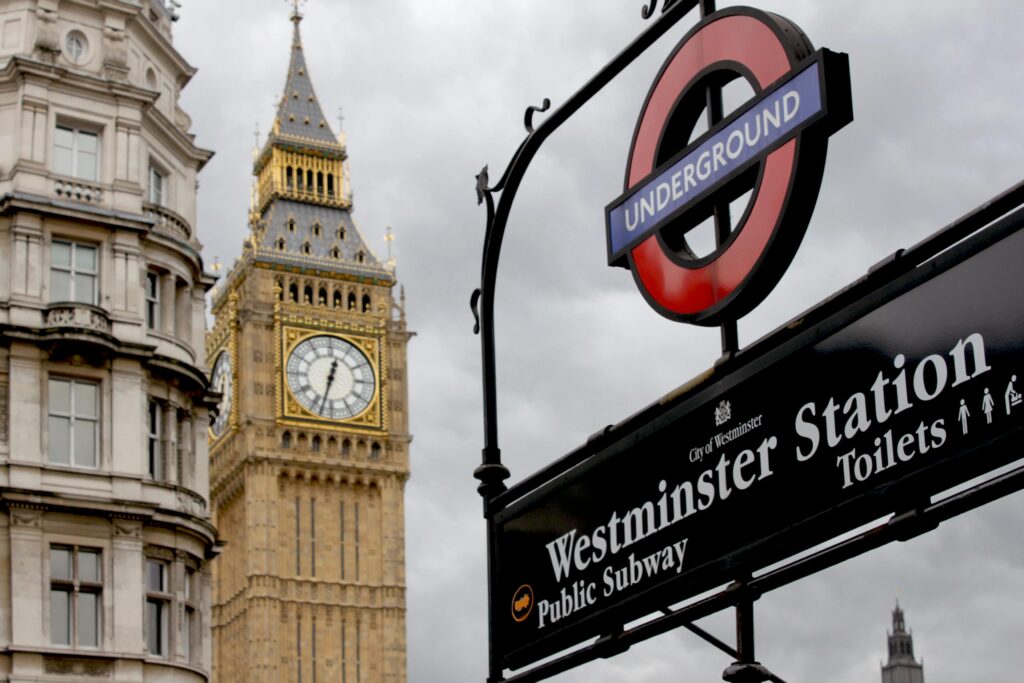 View of Big Ben and Westminster Station sign in London, England, capturing iconic British landmarks.