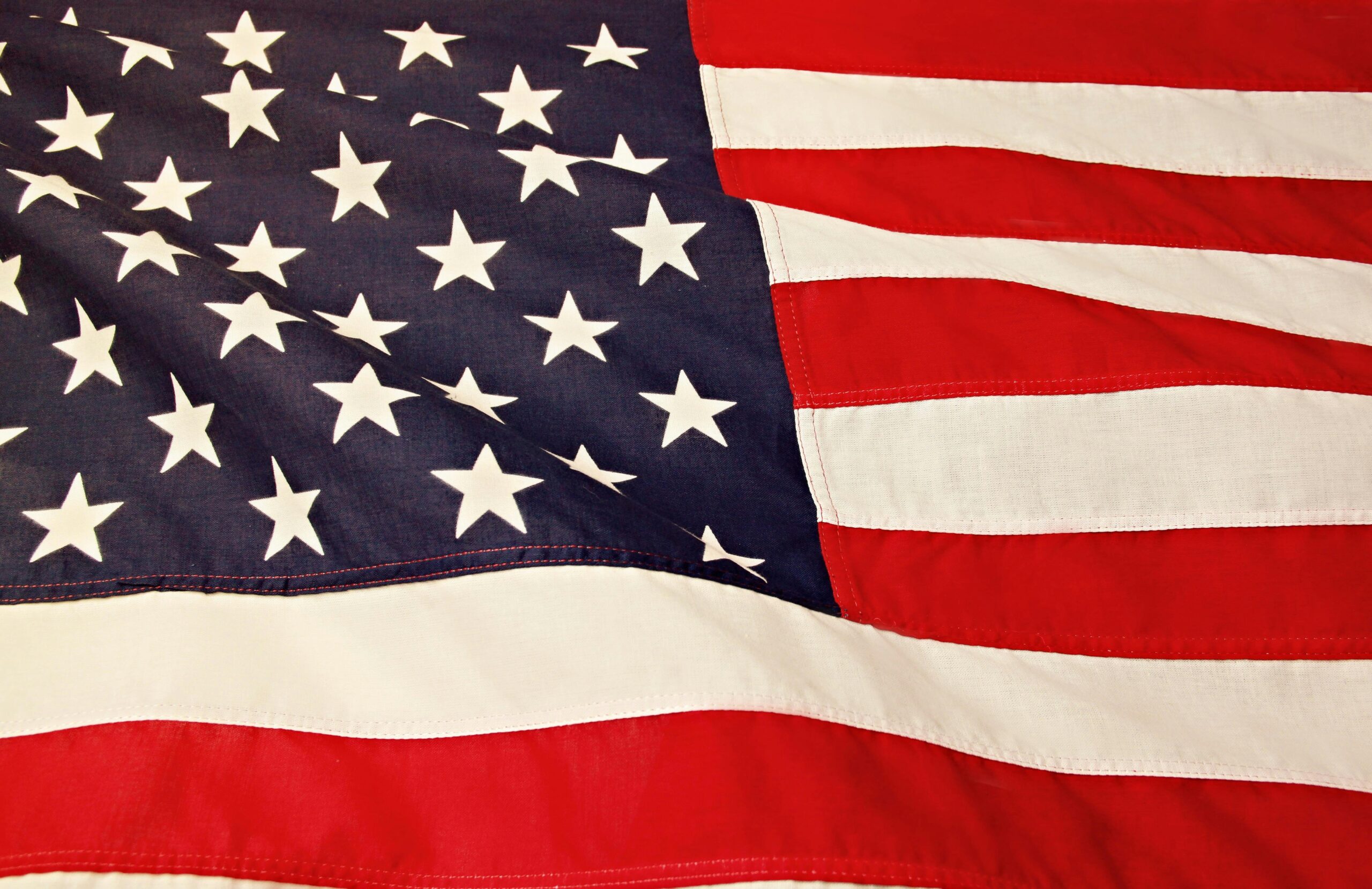 Detailed image of the American flag showcasing the stars and stripes symbolizing USA's patriotism and pride.