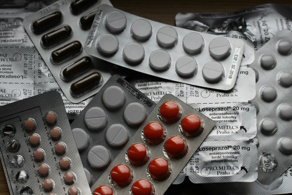 Close-up of various pills in blister packs showcasing medical and healthcare themes.