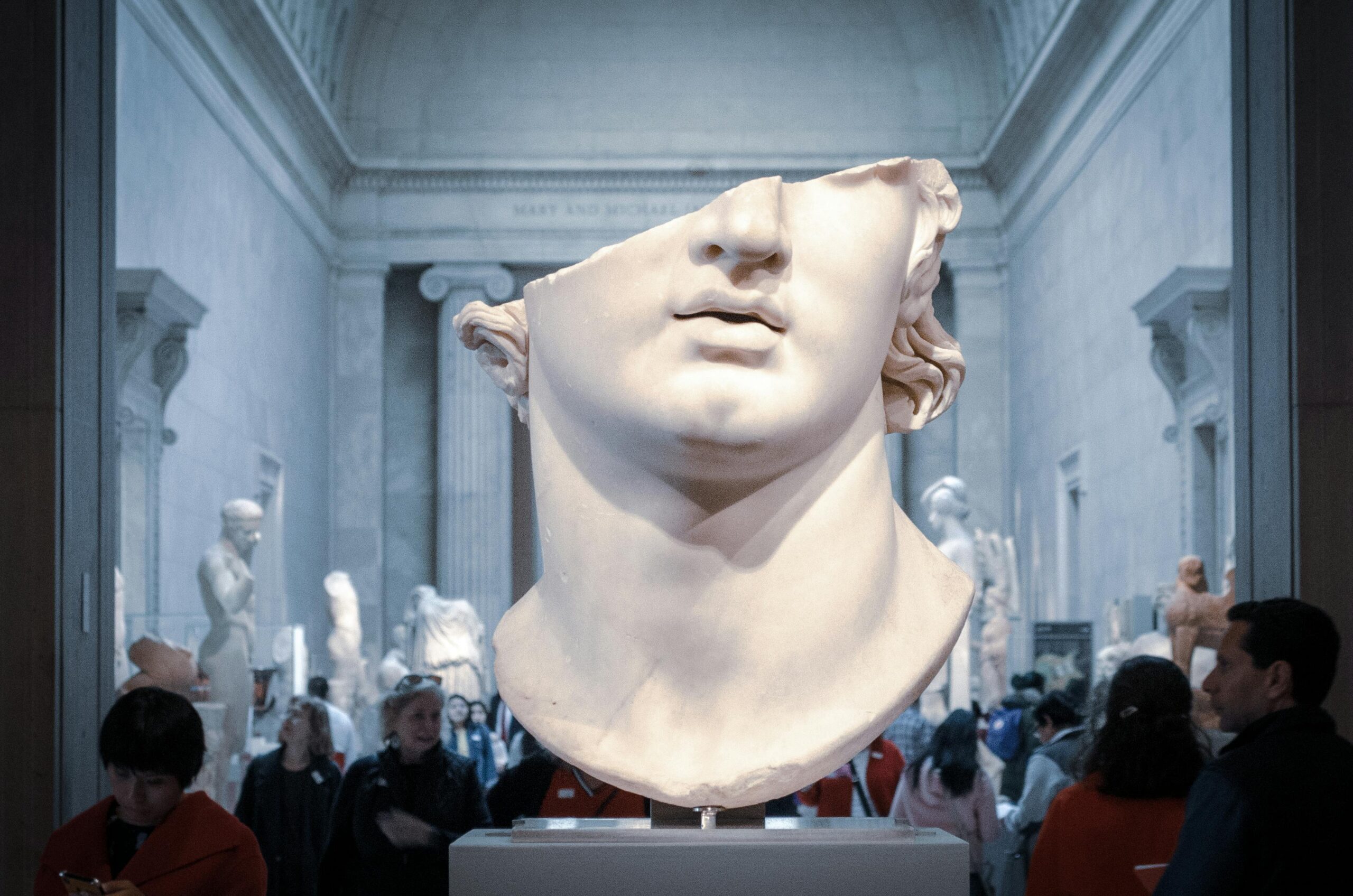 Greek marble head bust on display in a New York City museum exhibit.