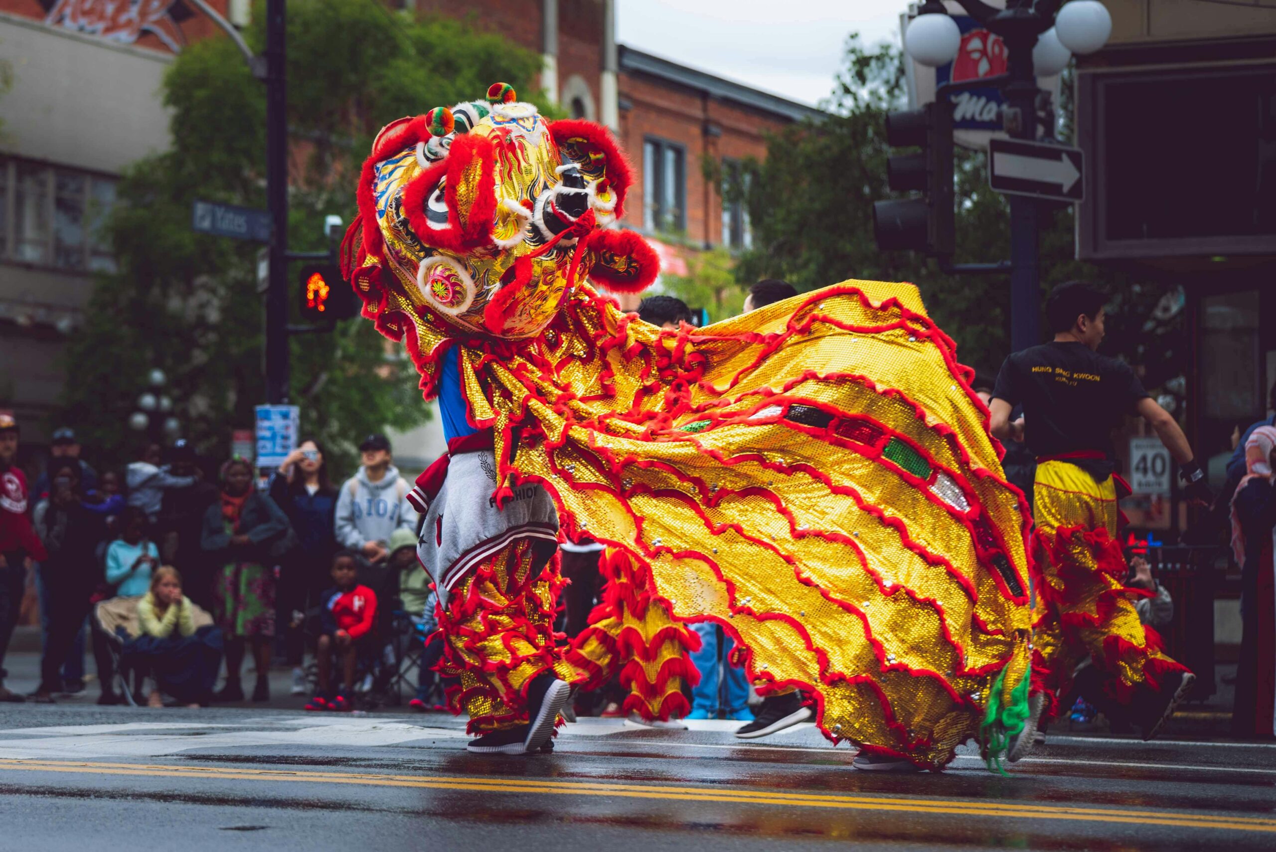 Vibrant dragon dance performance during a street parade in Victoria, BC, Canada, celebrating cultural heritage.