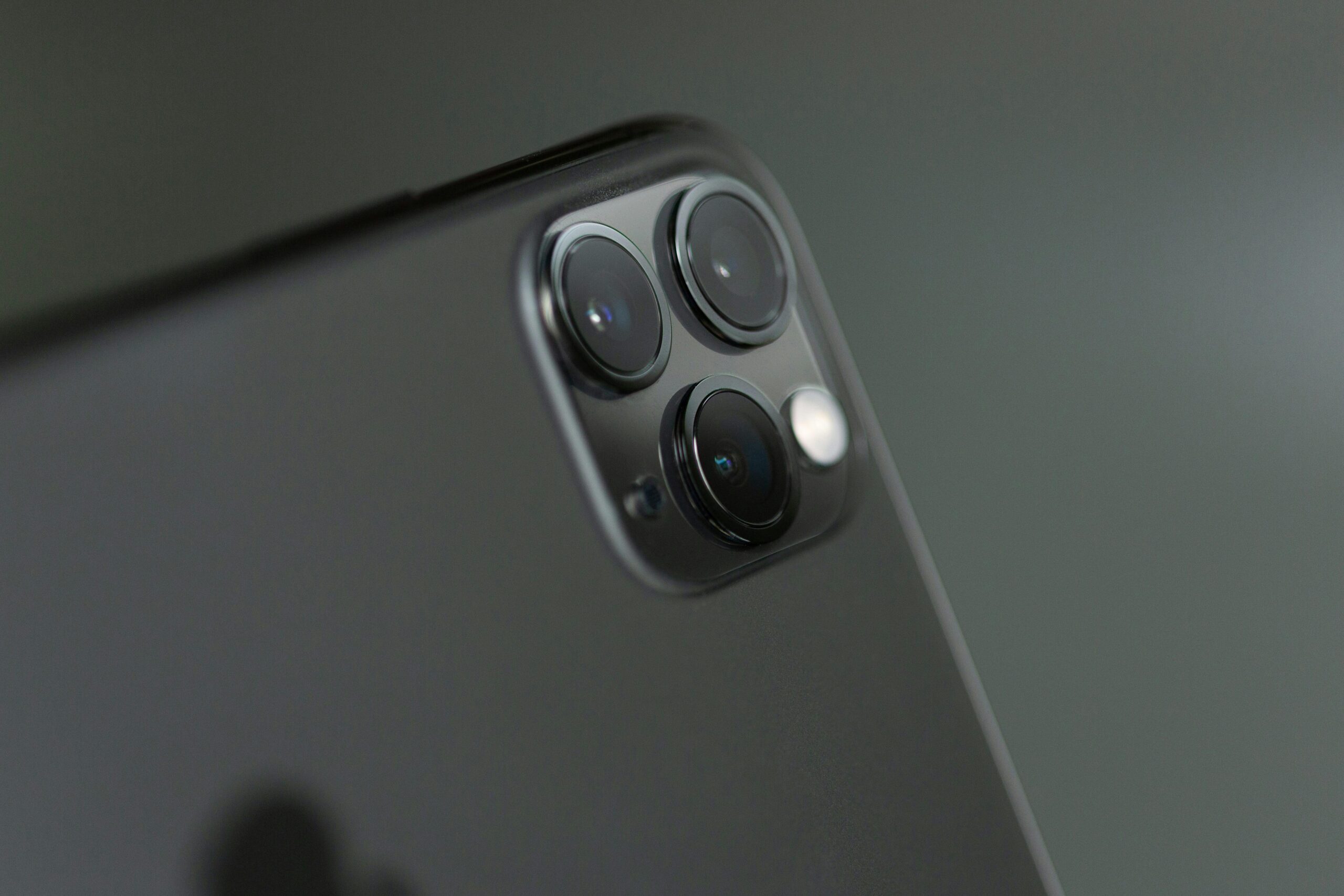 Detailed close-up of triple-camera system on a smartphone, showcasing modern technology.