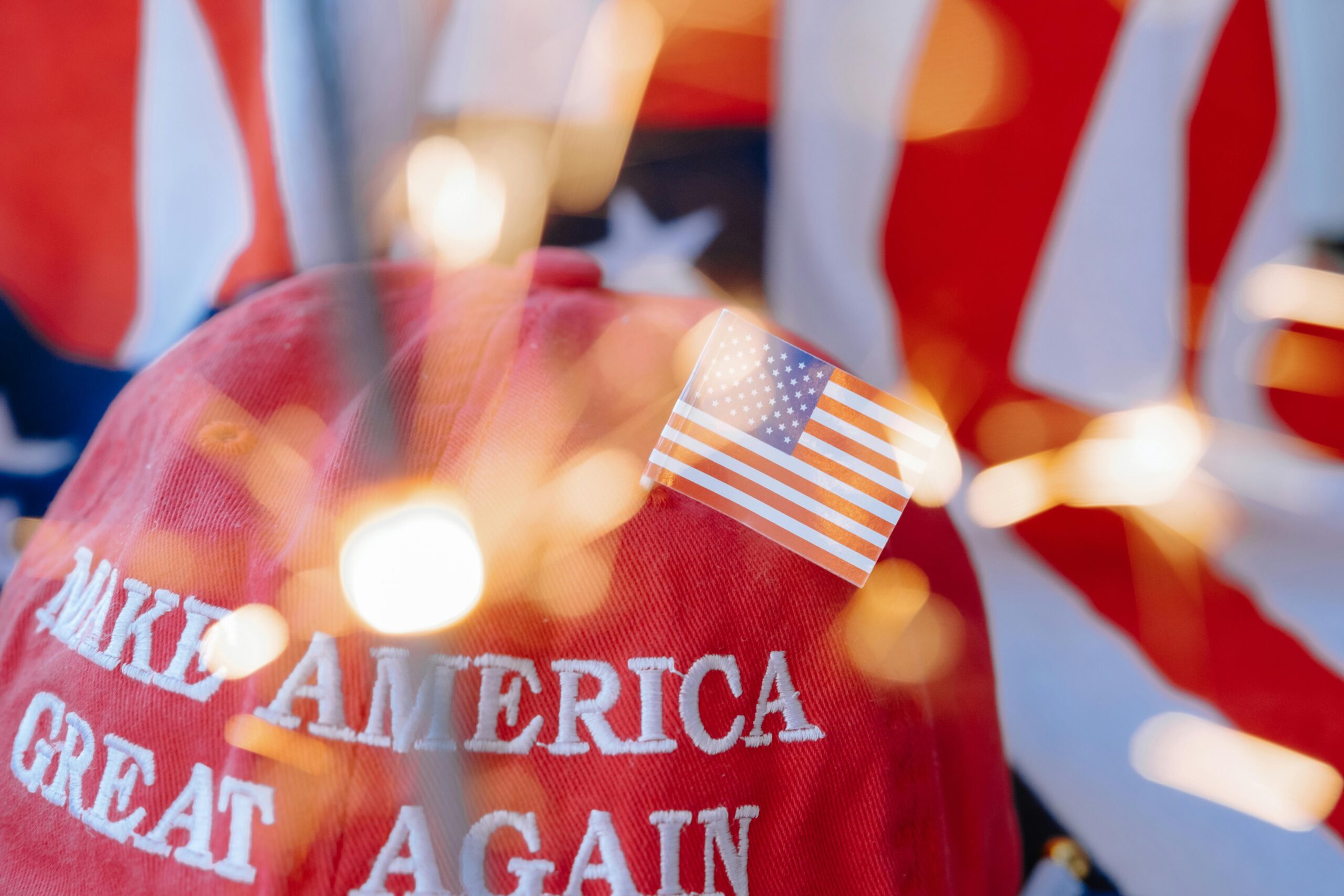 Close-up of a red cap with 'Make America Great Again' and a small American flag.