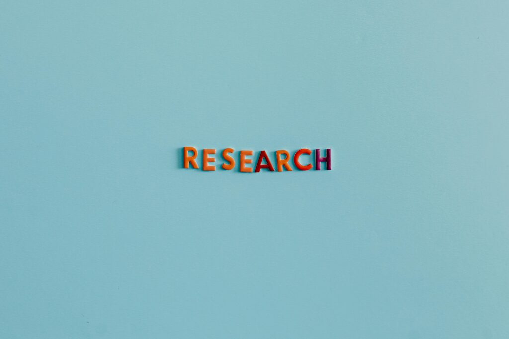 Colorful uppercase letters spelling 'RESEARCH' on a soft blue background. Ideal for education and science topics.