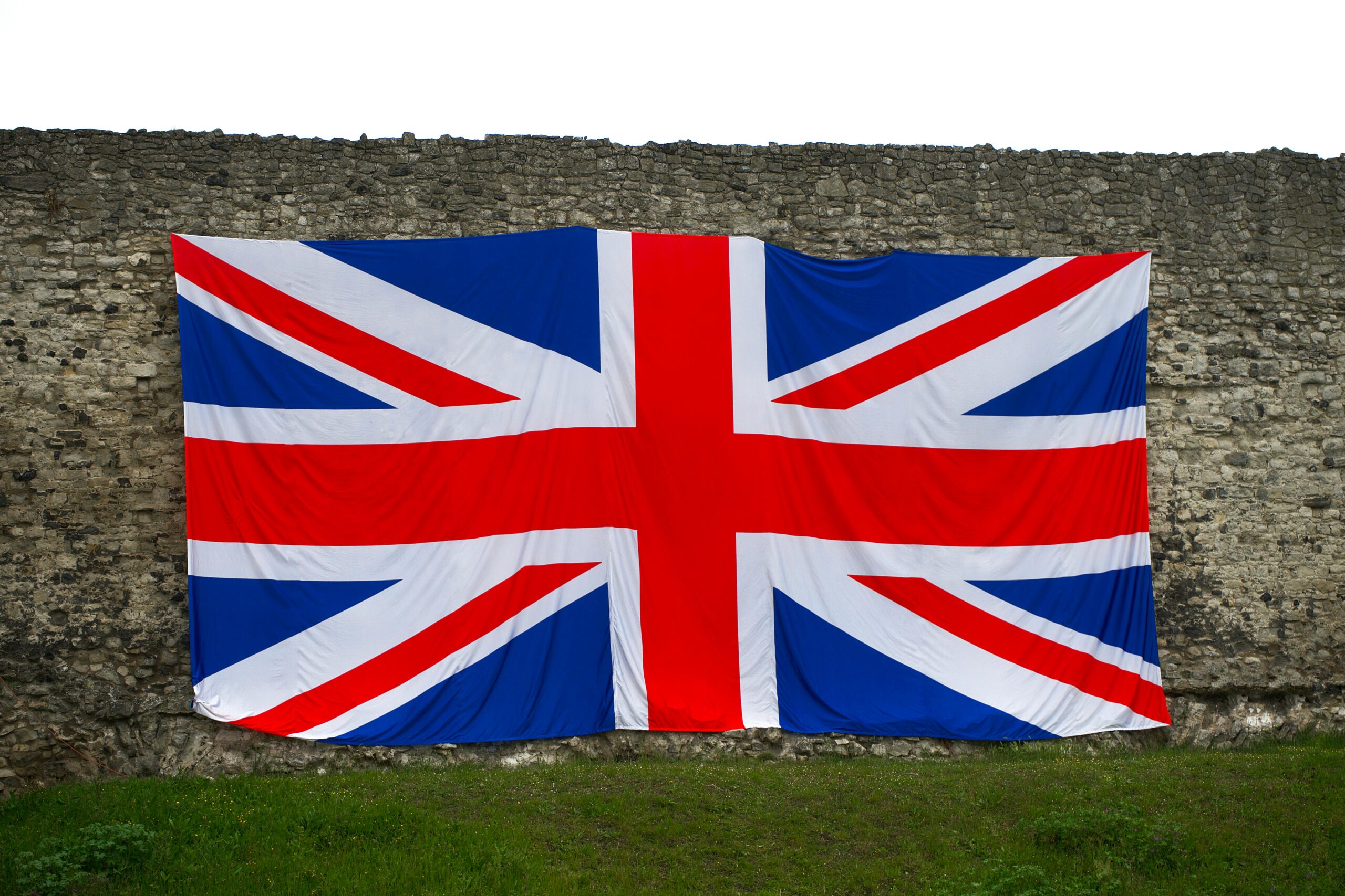 Union Jack flag draped over a historic stone wall, symbolizing British heritage in Rochester, England.