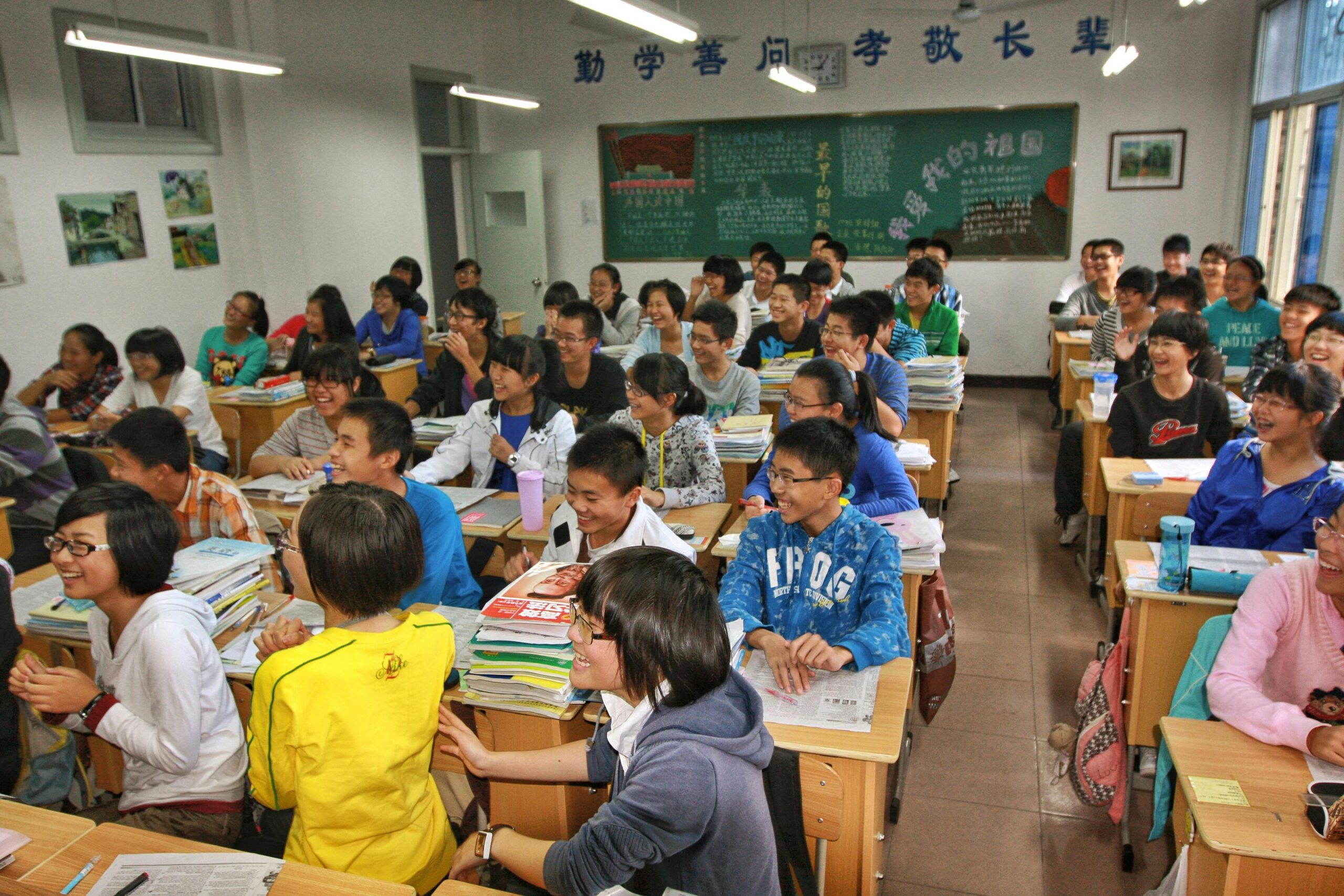 A lively classroom in Tianjin, China, with enthusiastic students participating in a lesson.