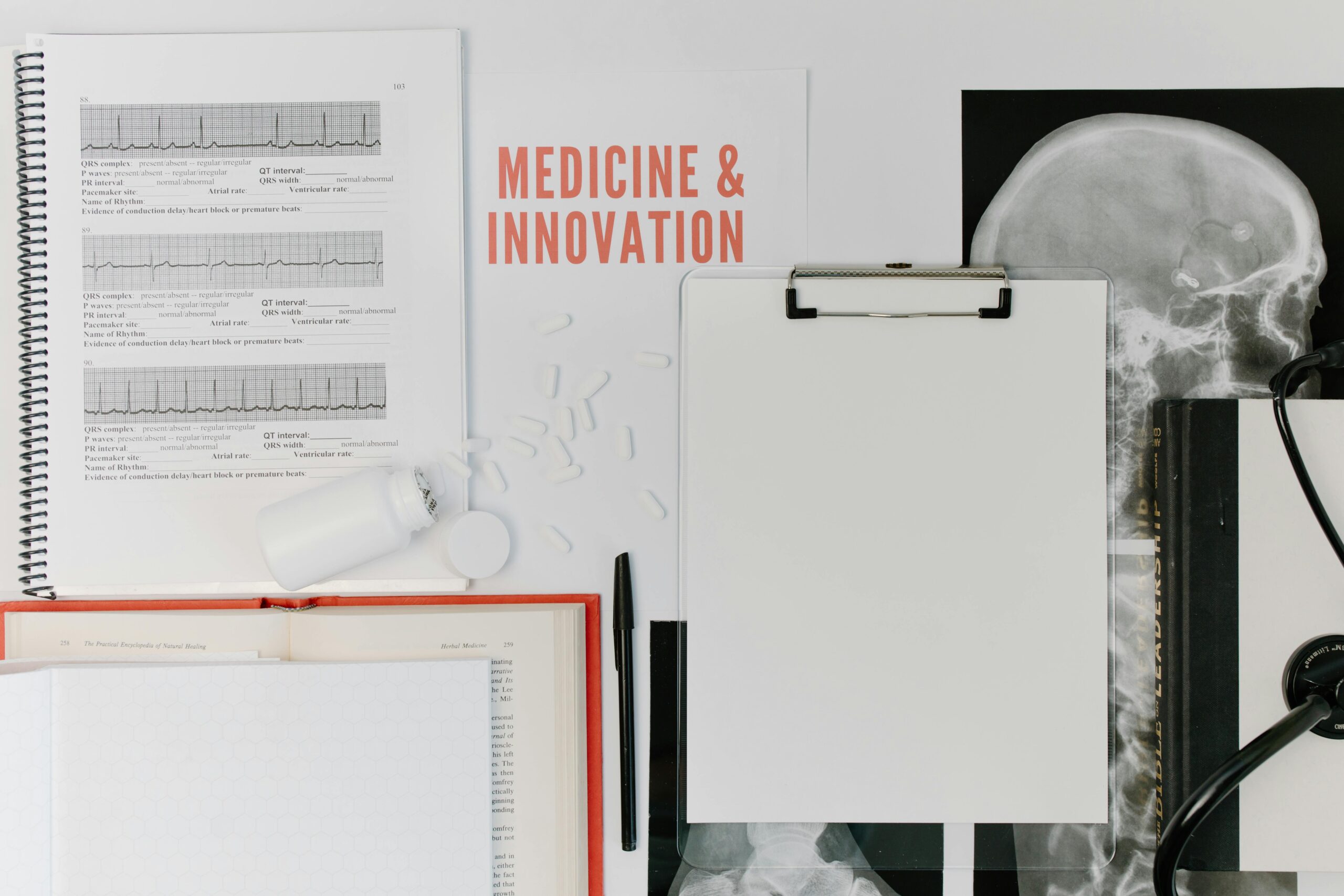 Flat lay of medical documents and equipment emphasizing innovation.