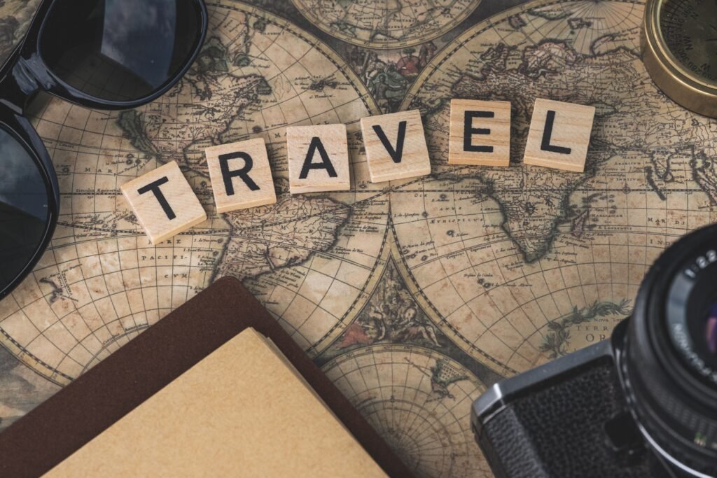 pexels-photo-14131701-14131701 Vintage map with travel essentials like camera and sunglasses arranged in a flat lay, perfect for adventure themes.