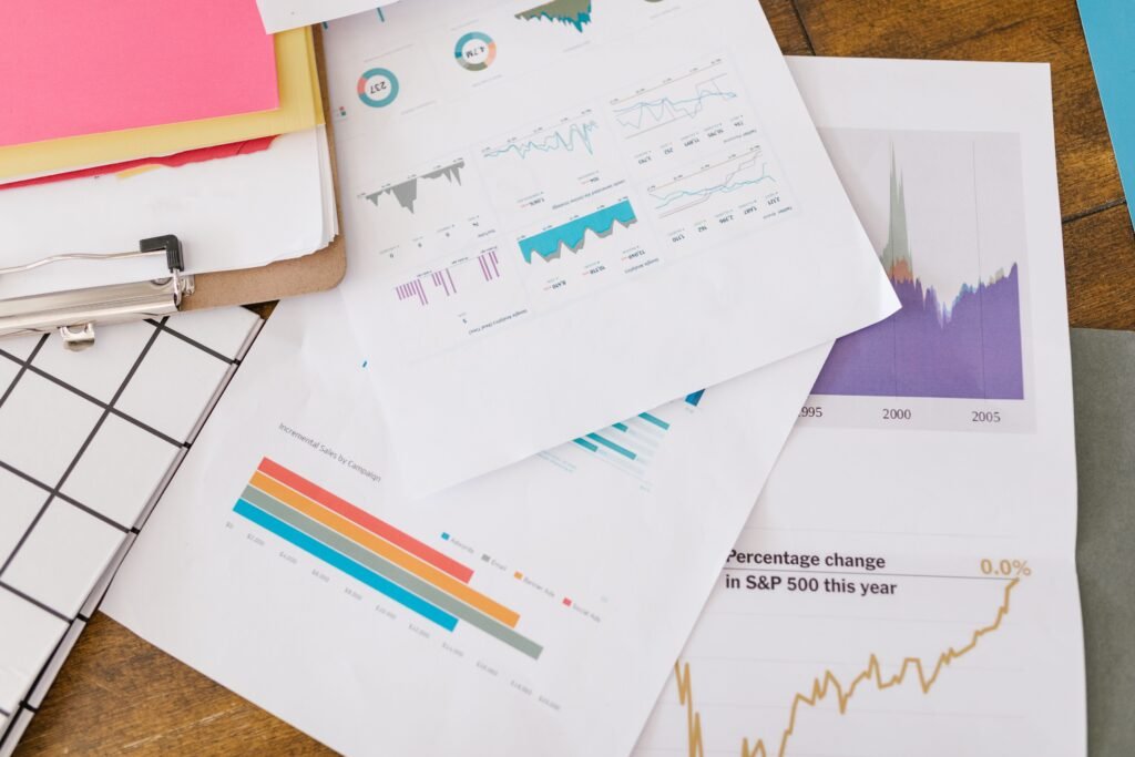 pexels-photo-7413936-7413936 Close-up of business analytics charts and graphs on papers and clipboard.