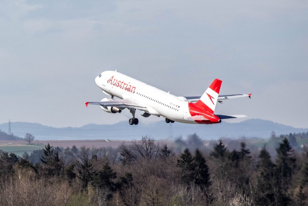 pexels-photo-20848209-20848209 Austrian Airlines airplane departing from Zurich airport, soaring over picturesque forests and fields.